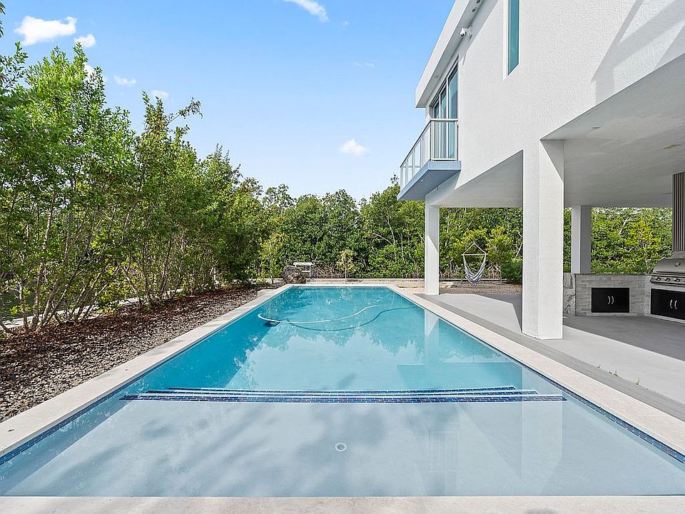 Long saltwater pool beside the elevated home